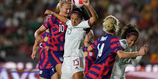 Mexico's Cristina Ferral (15) and United States' Lindsey Horan (10) fight for the ball during a CONCACAF Women's Championship soccer match in Monterrey, Mexico, Monday, July 11, 2022. 