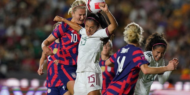 Mexico's Cristina Ferral (15) and United States' Lindsey Horan (10) fight for the ball during a CONCACAF Women's Championship soccer match in Monterrey, Mexico, Monday, July 11, 2022. 