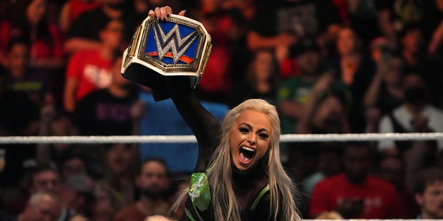 Jul 2, 2022; Las Vegas, NV, USA; Liv Morgan (black/green attire) celebrates after defeating Ronda Rousey during the women’s Smackdown Championship match after Morgan cashed in her Money In The Bank Briefcase at Money In The Bank at MGM Grand Garden Arena.