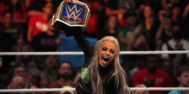 Jul 2, 2022; Las Vegas, NV, USA; Liv Morgan (black/green attire) celebrates after defeating Ronda Rousey during the women’s Smackdown Championship match after Morgan cashed in her Money In The Bank Briefcase at Money In The Bank at MGM Grand Garden Arena.