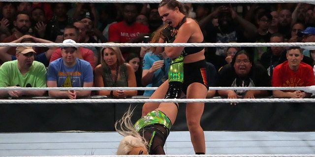Jul 2, 2022; Las Vegas, NV, VSA; Liv Morgan (black/green attire) battles Ronda Rousey (black attire) during the women’s Smackdown Championship match after Morgan cashed in her Money In The Bank Briefcase at Money In The Bank at MGM Grand Garden Arena.