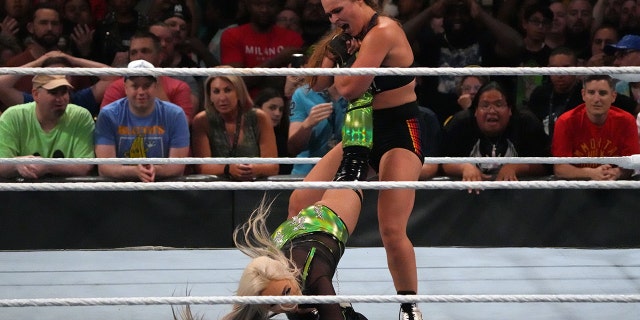 Jul 2, 2022; Las Vegas, NV, USA; Liv Morgan (black/green attire) battles Ronda Rousey (black attire) during the women’s Smackdown Championship match after Morgan cashed in her Money In The Bank Briefcase at Money In The Bank at MGM Grand Garden Arena.