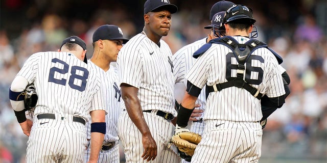 The New York Yankees' Luis Severino huddles with teammates during the first inning of a game against the Cincinnati Reds July 13, 2022, in New York. 