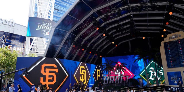 Logos from various teams are displayed during the 2022 MLB baseball draft, Sunday, July 17, 2022, in Los Angeles. 