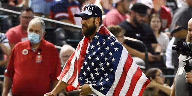 Pitcher Madison Bumgarner #40 of the Arizona Diamondbacks walks to the dugout wearing an American flag over his shoulders prior to a game against the San Francisco Giants at Chase Field on July 04, 2022 in Phoenix, Arizona. 