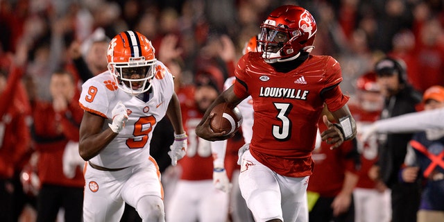 Louisville Cardinals quarterback Malik Cunningham (3) rushes to the end zone as Clemson Tigers safety R.J. Mickens (9) chases during the college football game between the Clemson Tigers and the Louisville Cardinals on Nov. 6, 2021, at Cardinal Stadium in Louisville, Kentucky.