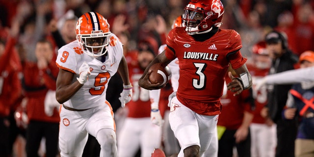 Louisville Cardinals quarterback Malik Cunningham (3) rushes to the end zone as Clemson Tigers safety R.J. Mickens (9) chases during the college football game between the Clemson Tigers and the Louisville Cardinals on Nov. 6, 2021, at Cardinal Stadium in Louisville, Kentucky.
