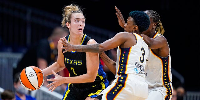 Dallas Wings guard Marina Mabrey (3) is defended by Indiana Fever guard Danielle Robinson (3) in the first half of a WNBA basketball game in Indianapolis, Sunday, July 24, 2022. 