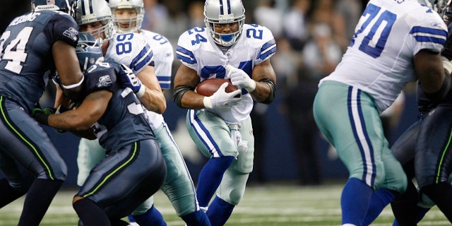 Dallas Cowboys running back Marion Barber, #24, runs the football against the Seahawks during game between the Seattle Seahawks and the Dallas Cowboys.