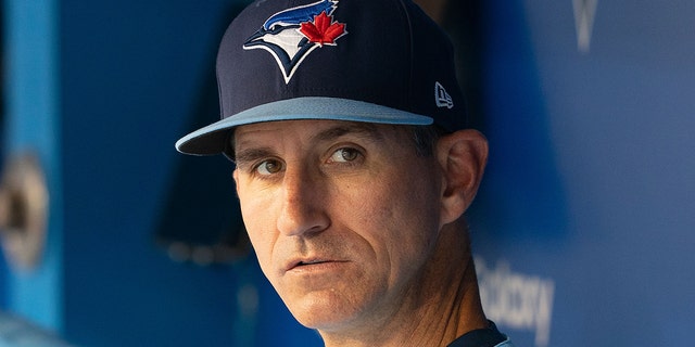 Blue Jays first base coach Mark Budzinski sits in the dugout before a game against the Oakland Athletics at Rogers Center in Toronto on September 3, 2021.