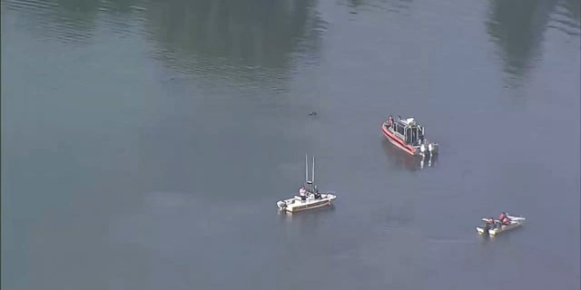 First responders searched the Mystic River after a Massachusetts Bay Transportation Authority Orange Line train caught fire and passengers evacuated, July 21, 2022.