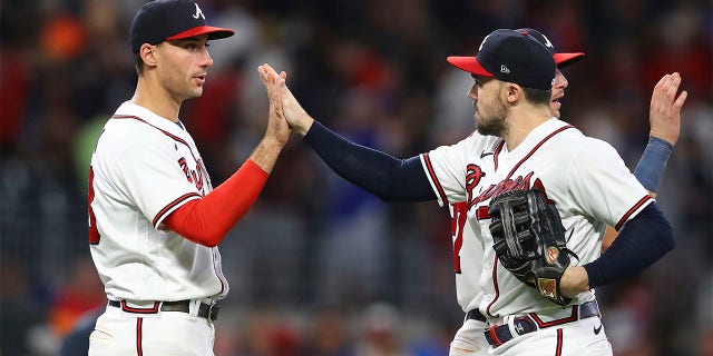 Atlanta Braves first baseman Matt Olson, left, and outfielder Adam Duvall, who both had two-run home runs in the game, give each other a high five while celebrating beating the New York Mets in a baseball game on Tuesday, July 12, 2022, in Atlanta.