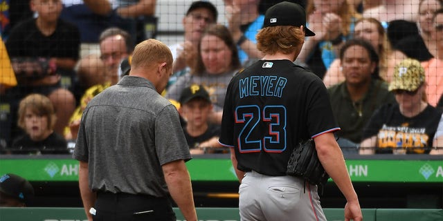 Max Meyer #23 of the Miami Marlins walks to the dugout with a trainer after leaving the game against the Pittsburgh Pirates with an apparent injury in the first inning at PNC Park on July 23, 2022 in Pittsburgh, Pennsylvania. (Photo by Justin Berl/Getty Images)