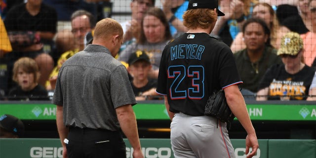 Max Meyer #23 of the Miami Marlins walks to the dugout with a trainer after leaving the game against the Pittsburgh Pirates with an apparent injury in the first inning at PNC Park on July 23, 2022 in Pittsburgh, Pennsylvania. (Photo by Justin Berl/Getty Images)
