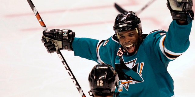 FILE - San Jose Sharks' Mike Grier, top, celebrates with Patrick Marleau, #12, after Marleau's third-period goal against the Columbus Blue Jackets during an NHL hockey game in San Jose, Calif., Tuesday, Oct. 14, 2008. 