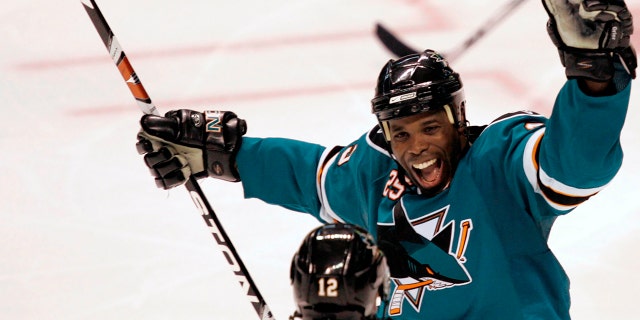 FILE - Mike Grier of the San Jose Sharks, top, with Patrick Marleau, #12, after Marleau's third-period goal against the Columbus Blue Jackets during an NHL hockey game in San Jose, Calif., Tuesday, October 14, 2008 Celebrate. 