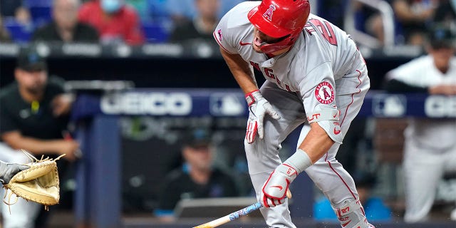 Los Angeles Angels' Mike Trout reacts after being hit by a pitch thrown by Miami Marlins' Trevor Rogers during the fifth inning of a baseball game, Wednesday, July 6, 2022, in Miami. 