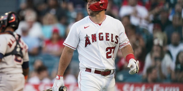 Los Angeles Angels' Mike Trout walks toward the dugout after striking out against the Houston Astros during the first inning of a baseball game Tuesday, July 12, 2022, in Anaheim, Calif. 