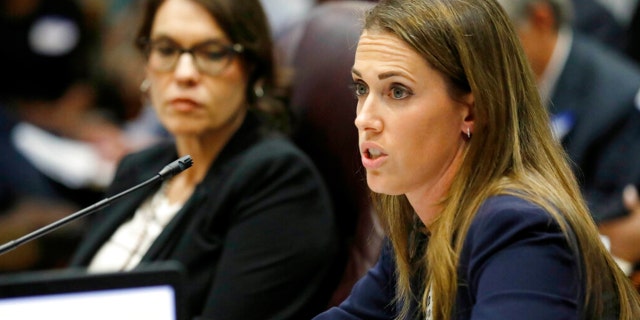 FILE: Paula Vanderford, chief accountability officer for the Mississippi Department of Education, left, listens to Erin Meyer, a special attorney general assigned to the department, in Jackson, Miss.