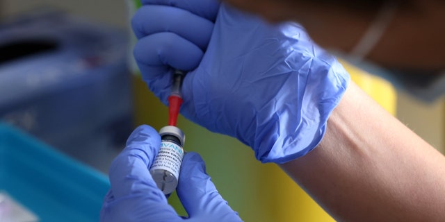 A medical professional prepares a dose of the monkeypox vaccine on July 23, 2022, in London. 