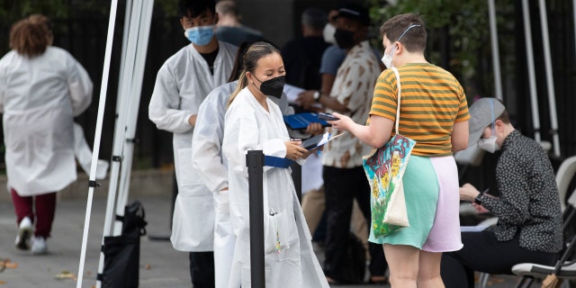 People wait to receive the monkeypox vaccine at a mass vaccination site in Manhattan, New York City, July 26, 2022.