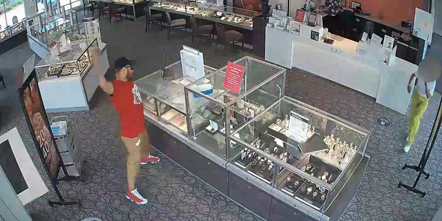 The suspect repeatedly smashed a brick into a jewelry case but failed to break it open.