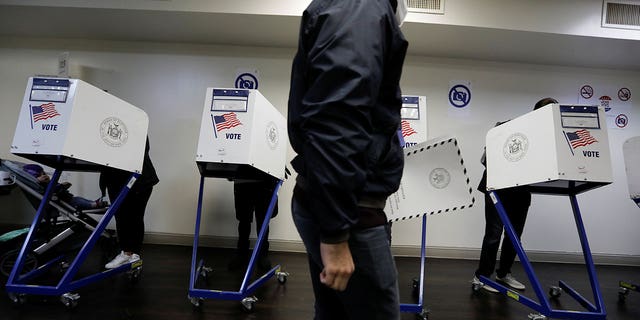 Voters fill out ballots in voting booths in the New York City election at a polling location in the Manhattan borough of New York, U.S., November 2, 2021. REUTERS/Mike Segar