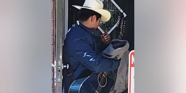 NYPD say a man spotted wearing a cowboy hat and holding a guitar approached a woman from behind and grabbed her buttock on a street corner. 