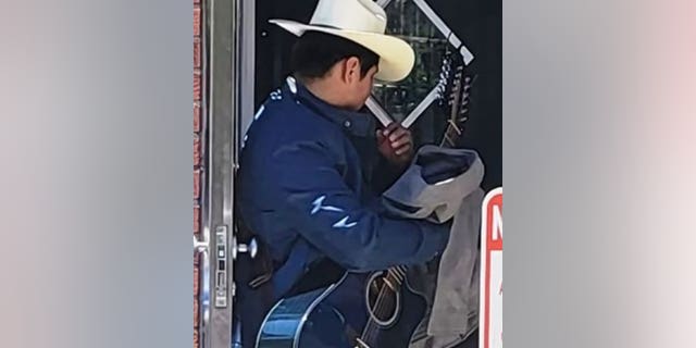 NYPD say a man spotted wearing a cowboy hat and holding a guitar approached a woman from behind and grabbed her buttock on a street corner.