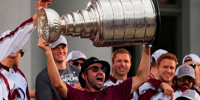 Colorado Avalanche center Nazem Kadri hoists the Stanley Cup at a rally for the NHL hockey champions Thursday, June 30, 2022, in Denver. 