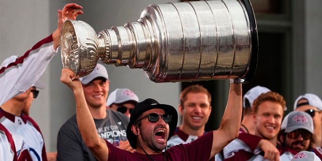 Colorado Avalanche center Nazem Kadri hoists the Stanley Cup at a rally for the NHL hockey champions Thursday, June 30, 2022, in Denver.
