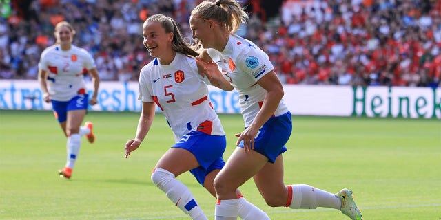 Netherlands' Stefanie van der Gragt, right, celebrates with her teammate Lynn Wilms after Switzerland's Ana-Maria Crnogorcevic scored an own goal during the Women Euro 2022 soccer match between Switzerland and Netherlands at Bramall Lane Stadium in Sheffield, England, Sunday, July 17, 2022.