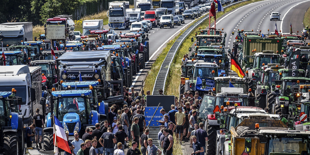 Economic Protests Break Out Worldwide Amid Mounting Challenges From Inflation, Ukraine War, Coronavirus 1 Farmers gather with their vehicles next to a Germany/Netherlands border sign during a protest on the A1 highway, near Rijssen, on June 29, against the Dutch government's nitrogen plans.