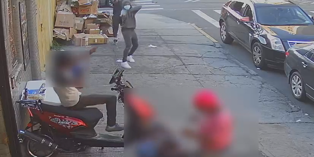 One of the two gunmen is seen in this surveillance video opening fire in Brookyn on Monday.