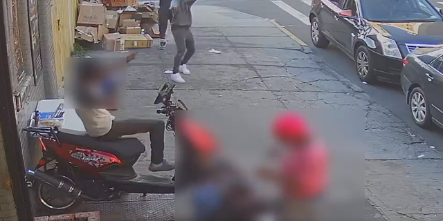 One of the two gunmen is seen in this surveillance video opening fire in Brookyn on Monday.