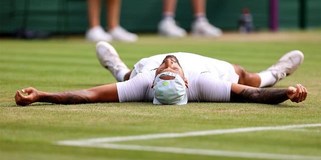 Nick Kyrgios of Australia celebrates winning match point against Cristian Garin of Chile during their Men's Singles Quarter Final match on day ten of The Championships Wimbledon 2022 at All England Lawn Tennis and Croquet Club on July 6, 2022 in London, England.