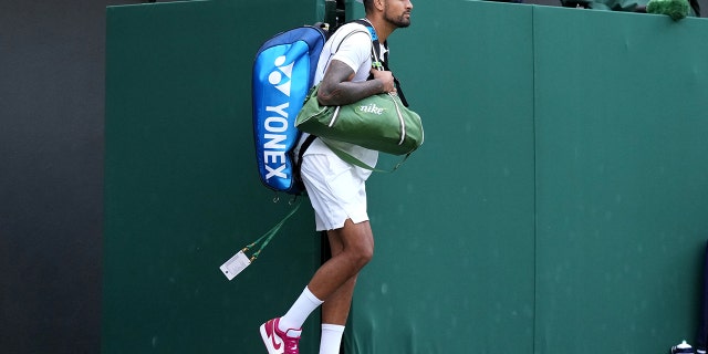 Australia's Nick Kyrgios walks onto court in red trainers on day eight of the 2022 Wimbledon Championships at the All England Lawn Tennis and Croquet Club, Wimbledon. Picture date: Monday July 4, 2022.