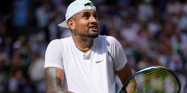 Nick Kyrgios argues with the umpire about the noise in the crowd during his match against Novak Djokovic at Wimbledon in London, Domenica, luglio 10, 2022.