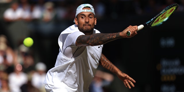 Nick Kyrgios stretches for a backhand shot during day fourteen of The Championships Wimbledon 2022 at All England Lawn Tennis and Croquet Club on July 10, 2022 in London, England.