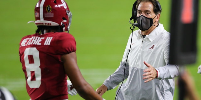 Alabama Crimson Tide head coach NIck Saban greets Alabama Crimson Tide wide receiver John Metchie III, #8, during the CFP National Championship game between the Alabama Crimson Tide and the Ohio State Buckeyes on January 11, 2021 at Hard Rock Stadium in Miami Gardens, Fl.