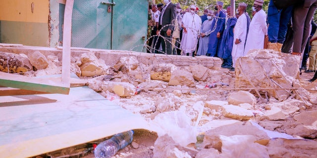 Nigerian President Muhammadu Buhari visits the prison where 600 prisoners escaped after an attack, in Abuja, Nigeria July 06, 2022.