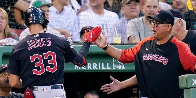 Cleveland Guardians' Nolan Jones (33) is congratulated by manager Terry Francona, right, after his three-run home run off Boston Red Sox starting pitcher Josh Winckowski during the third inning during a baseball game at Fenway Park, Tuesday, July 26, 2022, in Boston. 