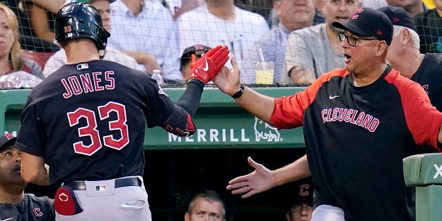 Nolan Jones is congratulated by Terry Francona