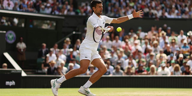 Novak Djokovic of Serbia plays a forehand against Jannik Sinner of Italy during their Men's Singles Quarter Final match on day nine of The Championships Wimbledon 2022 at All England Lawn Tennis and Croquet Club on July 05, 2022 in London, England. 