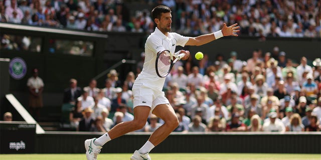 Novak Djokovic of Serbia plays a forehand against Jannik Sinner of Italy during their Men's Singles Quarter Final match on day nine of The Championships Wimbledon 2022 at All England Lawn Tennis and Croquet Club on July 05, 2022 in London, England. 