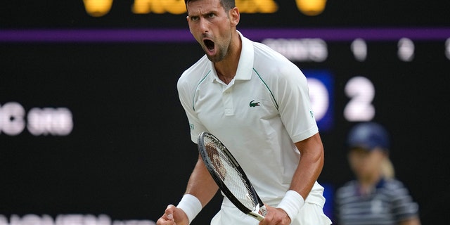 Serbia's Novak Djokovic celebrates winning a point against Tim van Rijthoven of the Netherlands during a men's fourth round singles match on day seven of the Wimbledon tennis championships in London, Sunday, July 3, 2022.