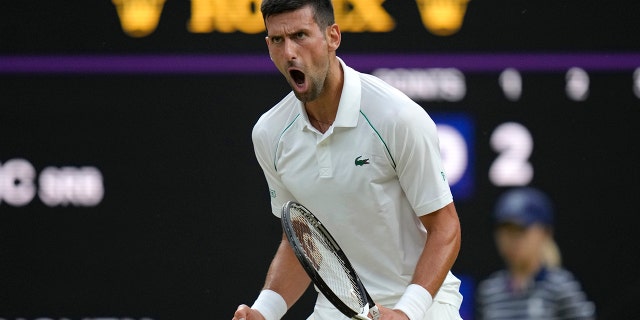 Serbia's Novak Djokovic celebrates winning a point against Tim van Rijthoven of the Netherlands during a men's fourth round singles match on day seven of the Wimbledon tennis championships in London, Sunday, July 3, 2022.