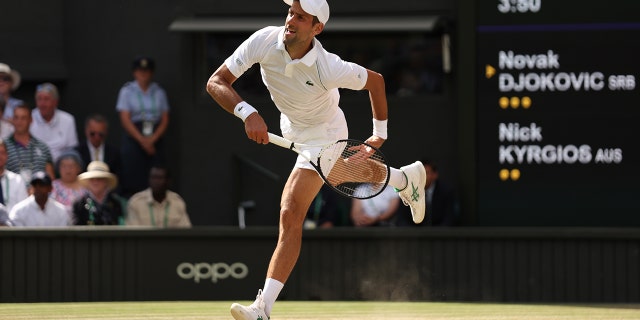 Novak Djokovic of Serbia serves against Nick Kyrgios of Australia during their Men's Singles Final match on day fourteen of The Championships Wimbledon 2022 at All England Lawn Tennis and Croquet Club on July 10, 2022 in London, England.