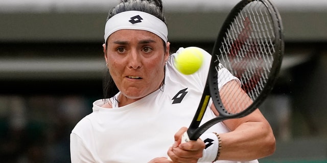 Tunisia's Ons Jabeur returns the ball to Belgium's Elise Mertens during a fourth round women's singles match on day seven of the Wimbledon tennis championships in London, Sunday, July 3, 2022.
