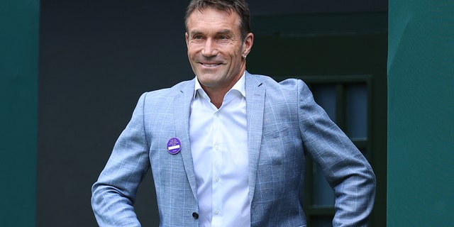 Former Wimbledon champion Pat Cash walks onto Centre Court at All England Lawn Tennis and Croquet Club on July 3, 2022, in London.